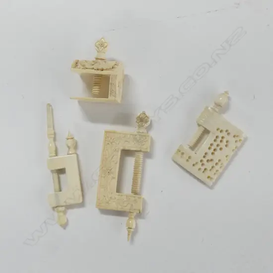 Four antique needlework clamps.